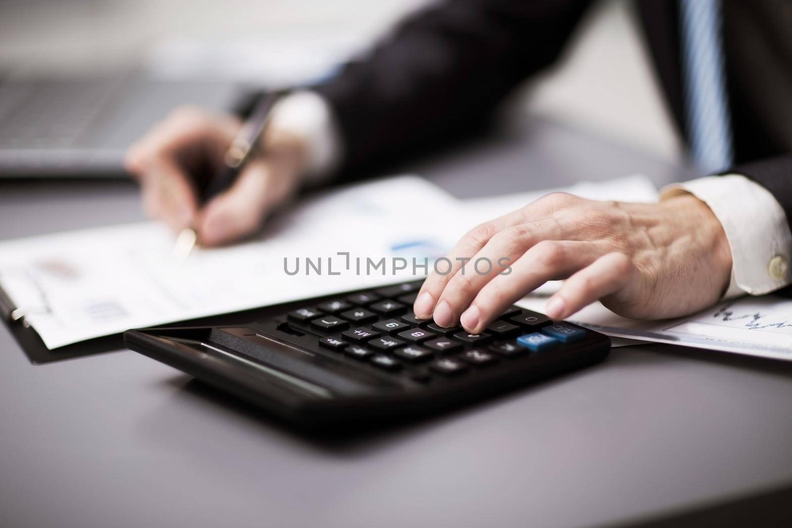 Man doing his accounting, financial adviser working by SmartPhotoLab