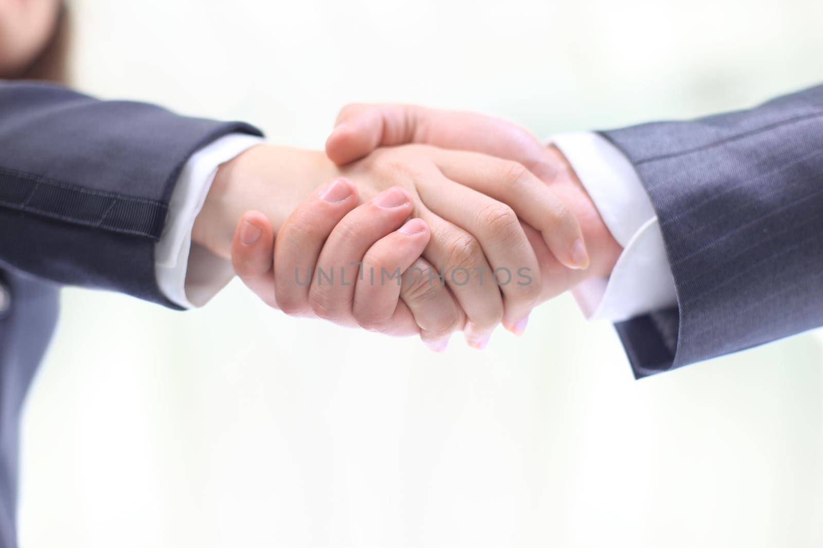 Handshake of the two businessmen, agreed in the contract, a close-up. Isolated on a white background.