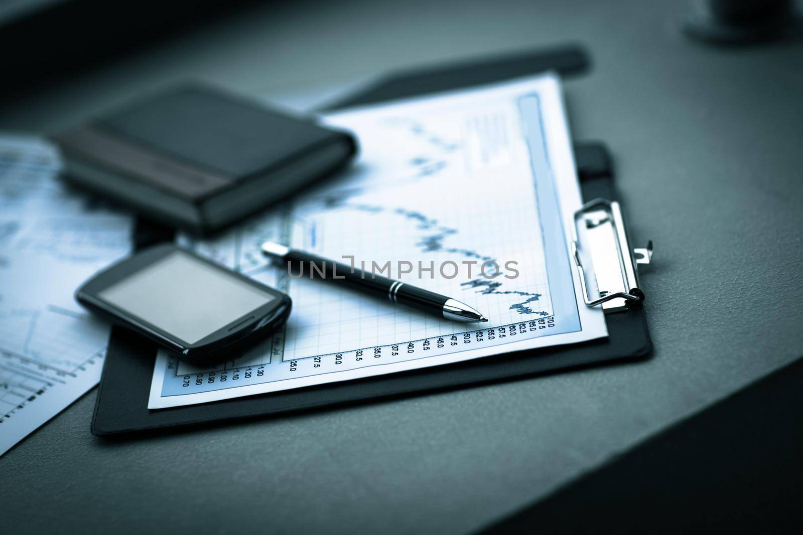 Business chart with smart phone and pen. accounting by SmartPhotoLab