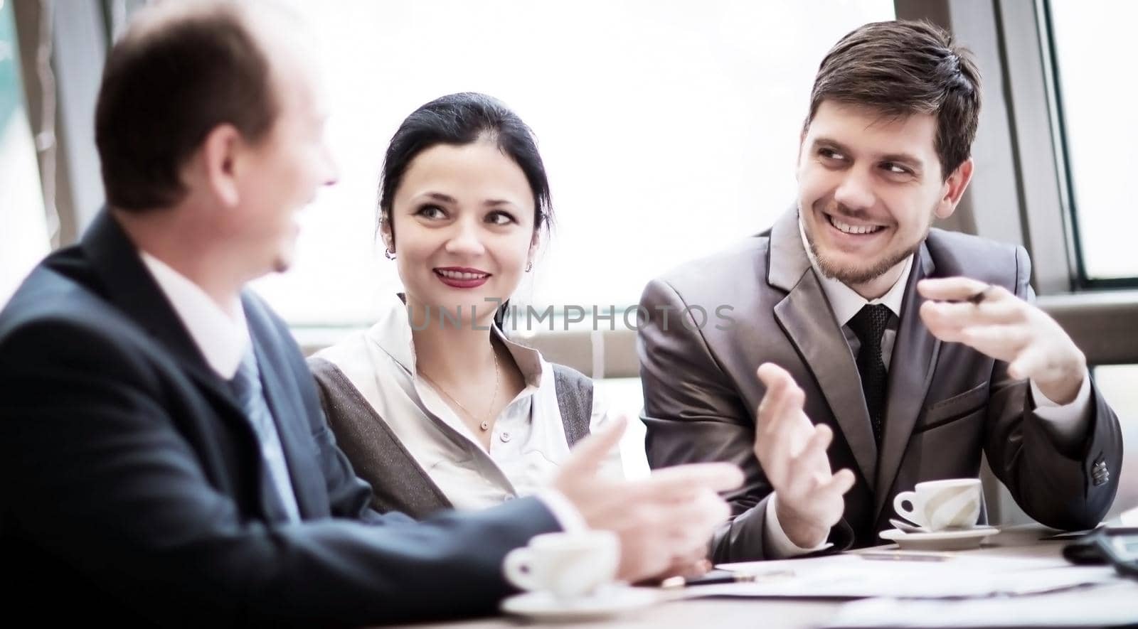 Portrait of smart business partners communicating at meeting, discussion