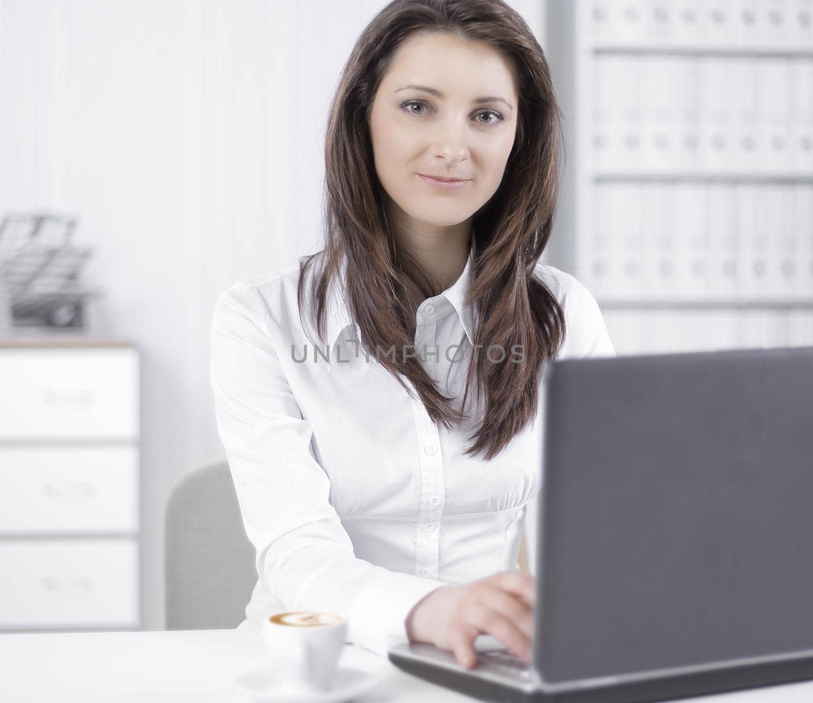 friendly female employee sitting at her Desk.photo with copy space
