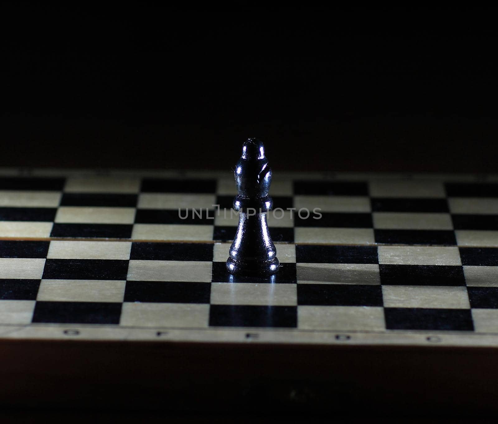 Composition with chessmen on glossy chessboard