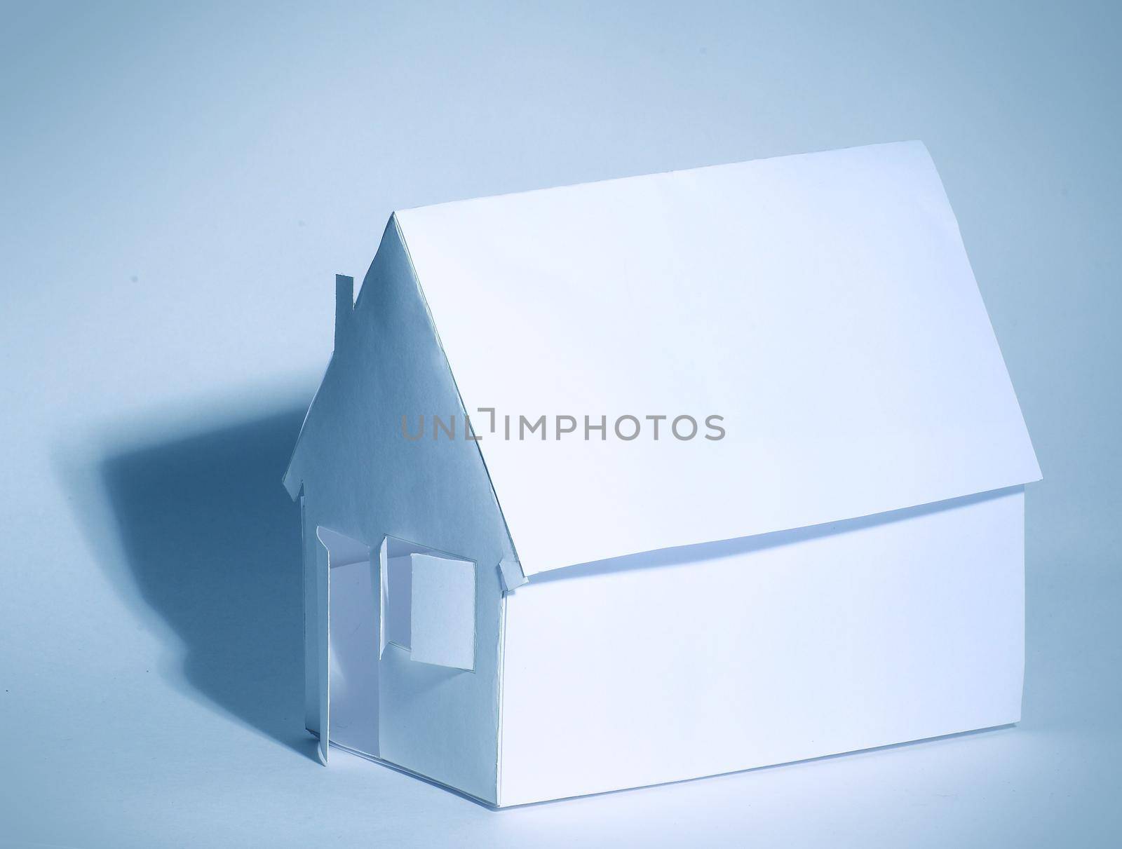 Paper house on a white background in cool colors by SmartPhotoLab