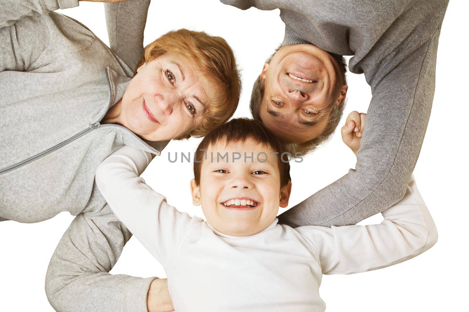Grandmother with grandfather and grandson hugging in a circle. concept-happy family by SmartPhotoLab