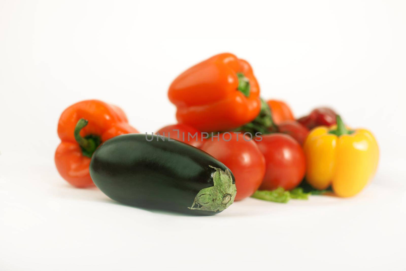 eggplant,tomatoes,peppers and a mobile phone.isolated on a white background.