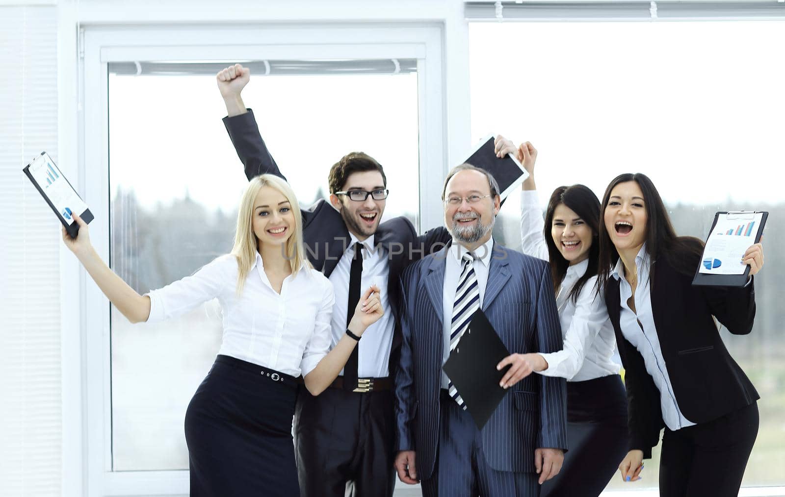 happy business team raising hands, rejoicing.the concept of success.photo with copy space