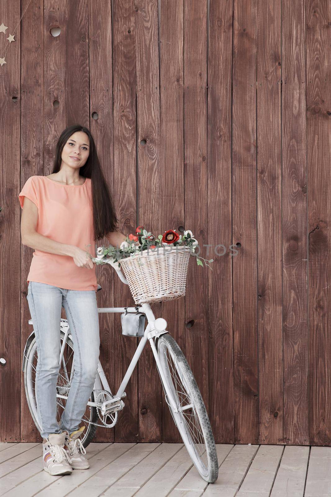 modern young woman with Bicycle and spring flowers in basket by SmartPhotoLab