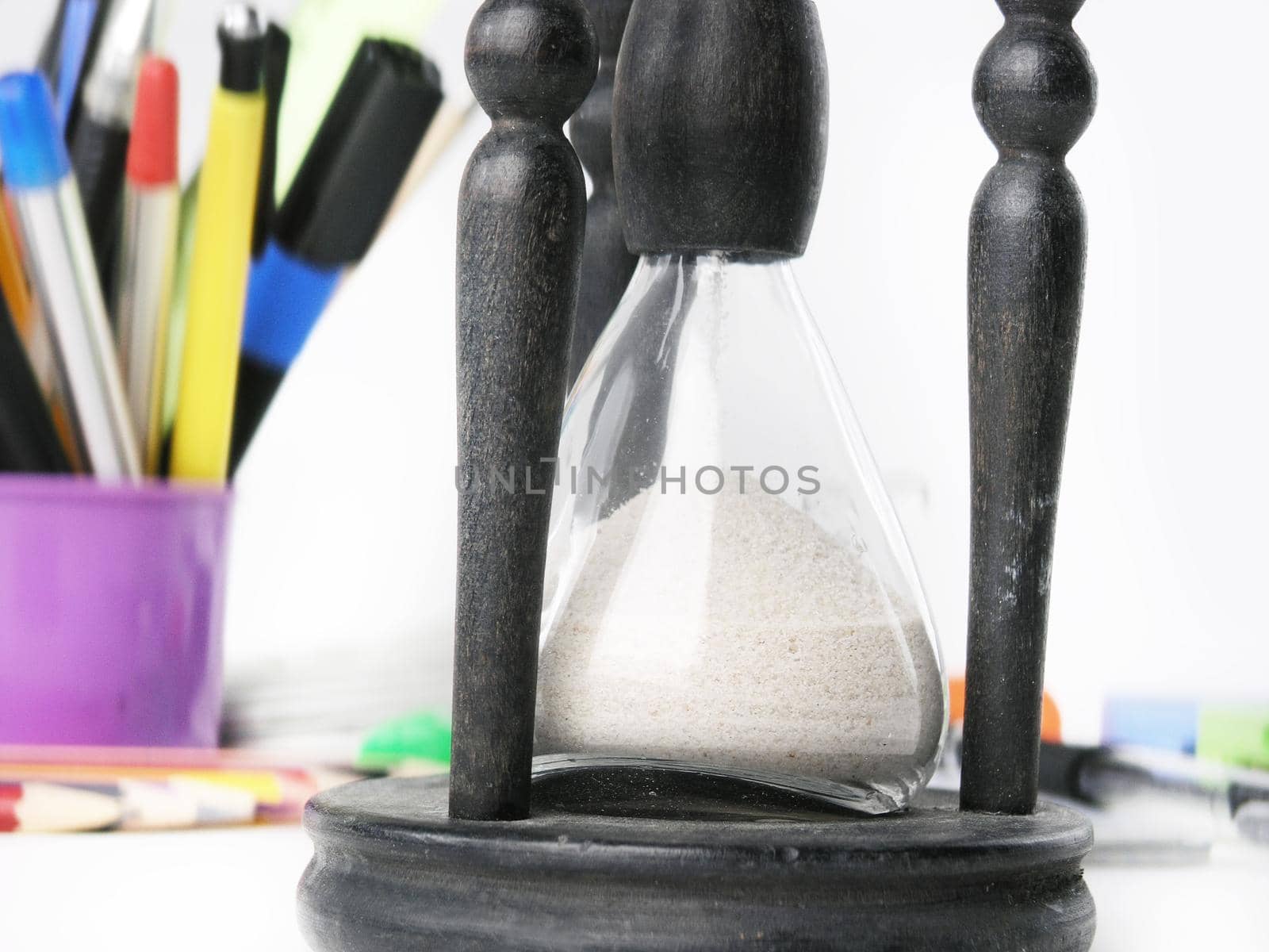 close up.hourglass on blurred background of office supplies by SmartPhotoLab