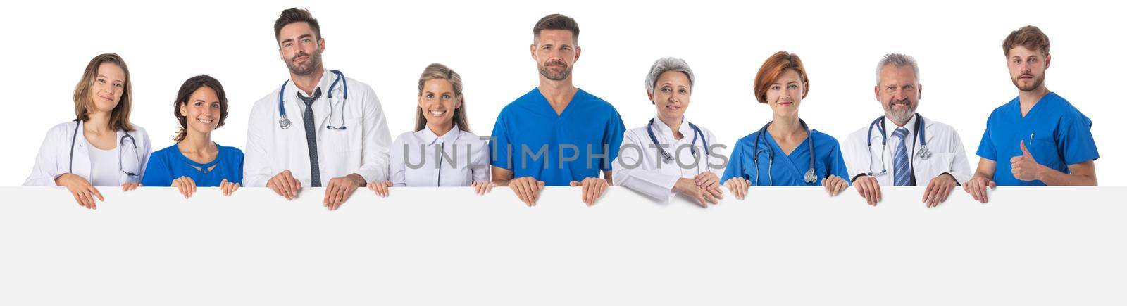 Group of doctors presenting empty banner. Isolated on white background, copy space for text