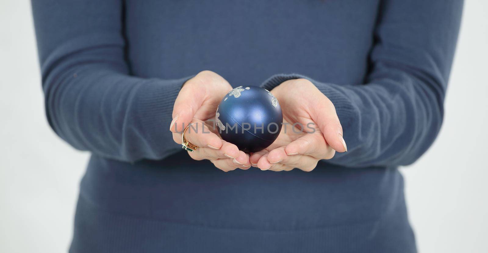 beautiful young woman holding a blue Christmas ball.isolated on white background