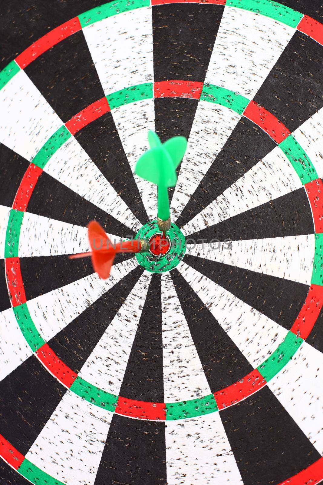 Darts game with a dart in the target center by SmartPhotoLab