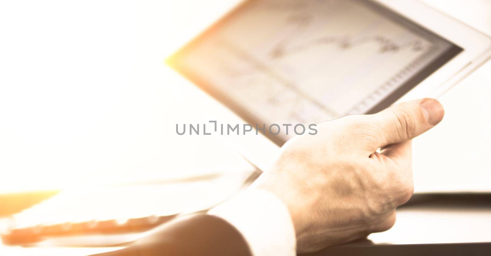 Businessman with finger touching screen of a digital tablet