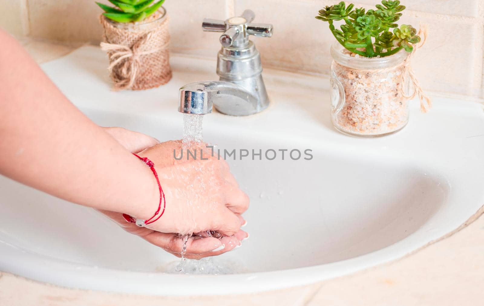 Close up of a person washing their hands with soap, concept of correct hand washing, ways to prevent covid19 by isaiphoto