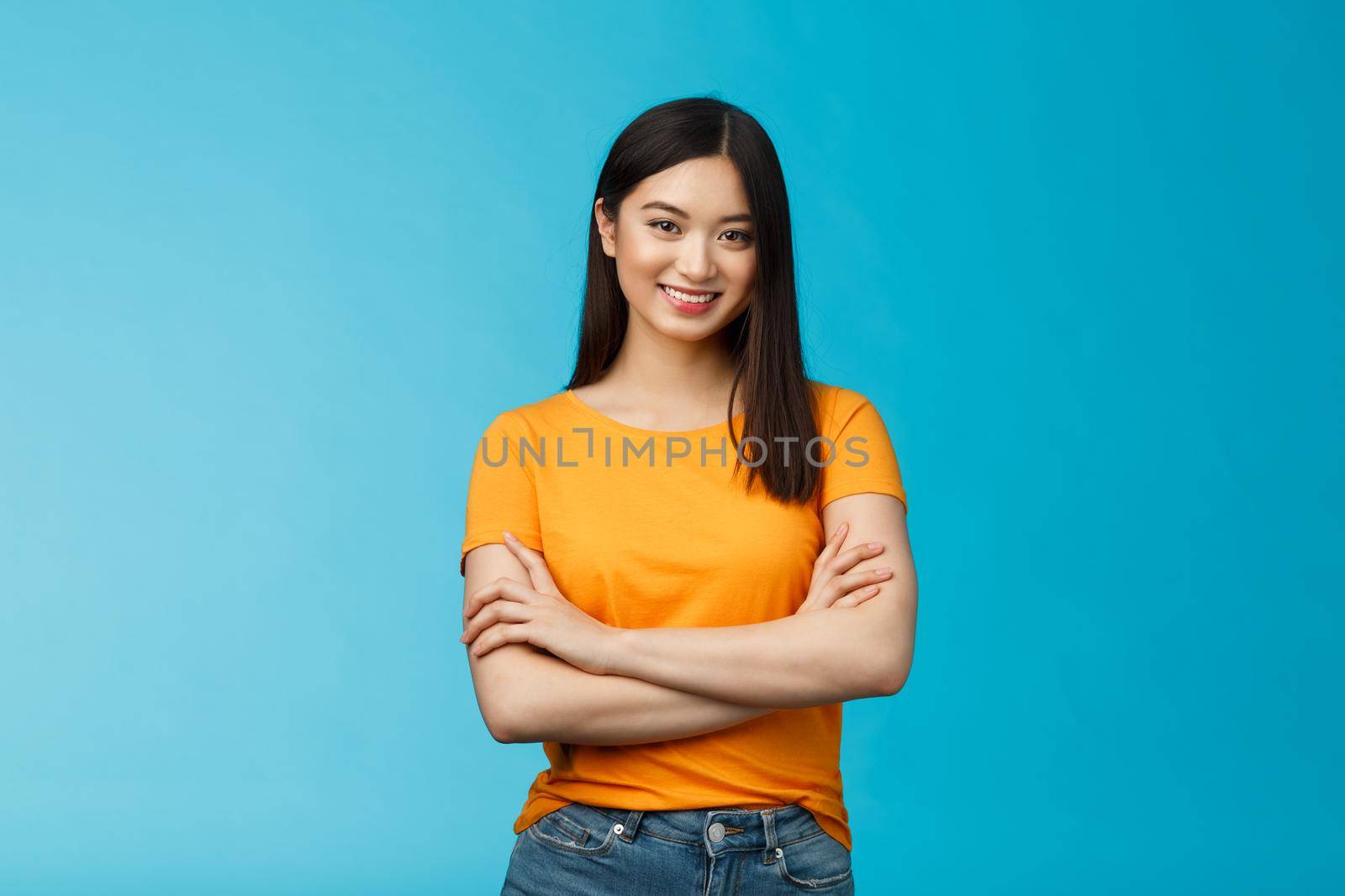 Confident assertive good-looking asian girl with dark short hairstyle cross arms chest self-assured, ready help give advice friendly smiling camera, stand blue background upbeat motivated by Benzoix