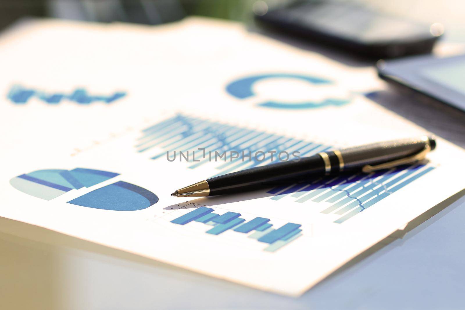 financial and business color charts and graphs on the table by SmartPhotoLab