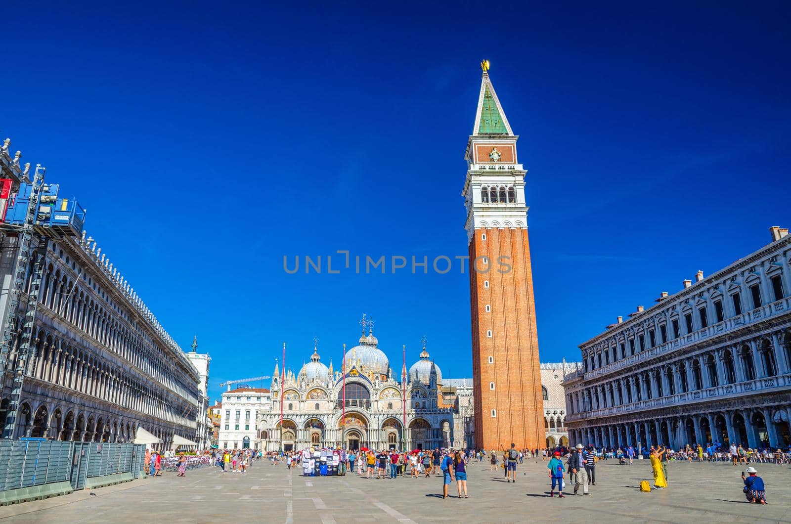 Venice, Italy, September 13, 2019: Piazza San Marco St Mark's Square, Patriarchal Cathedral Basilica of Saint Mark Archdiocese, Procuratie Vecchie and Campanile bell tower, blue sky, Veneto Region
