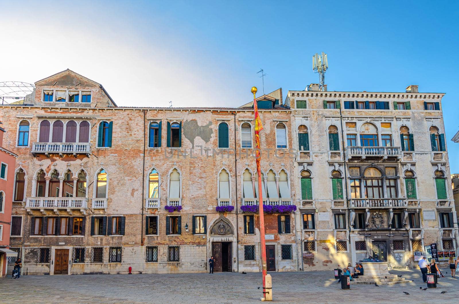 Venice, Italy, September 13, 2019: Campo San Maurizio square with Micromega Arte e Cultura MAC museum building and stone well in historical city centre San Marco sestiere, Veneto region
