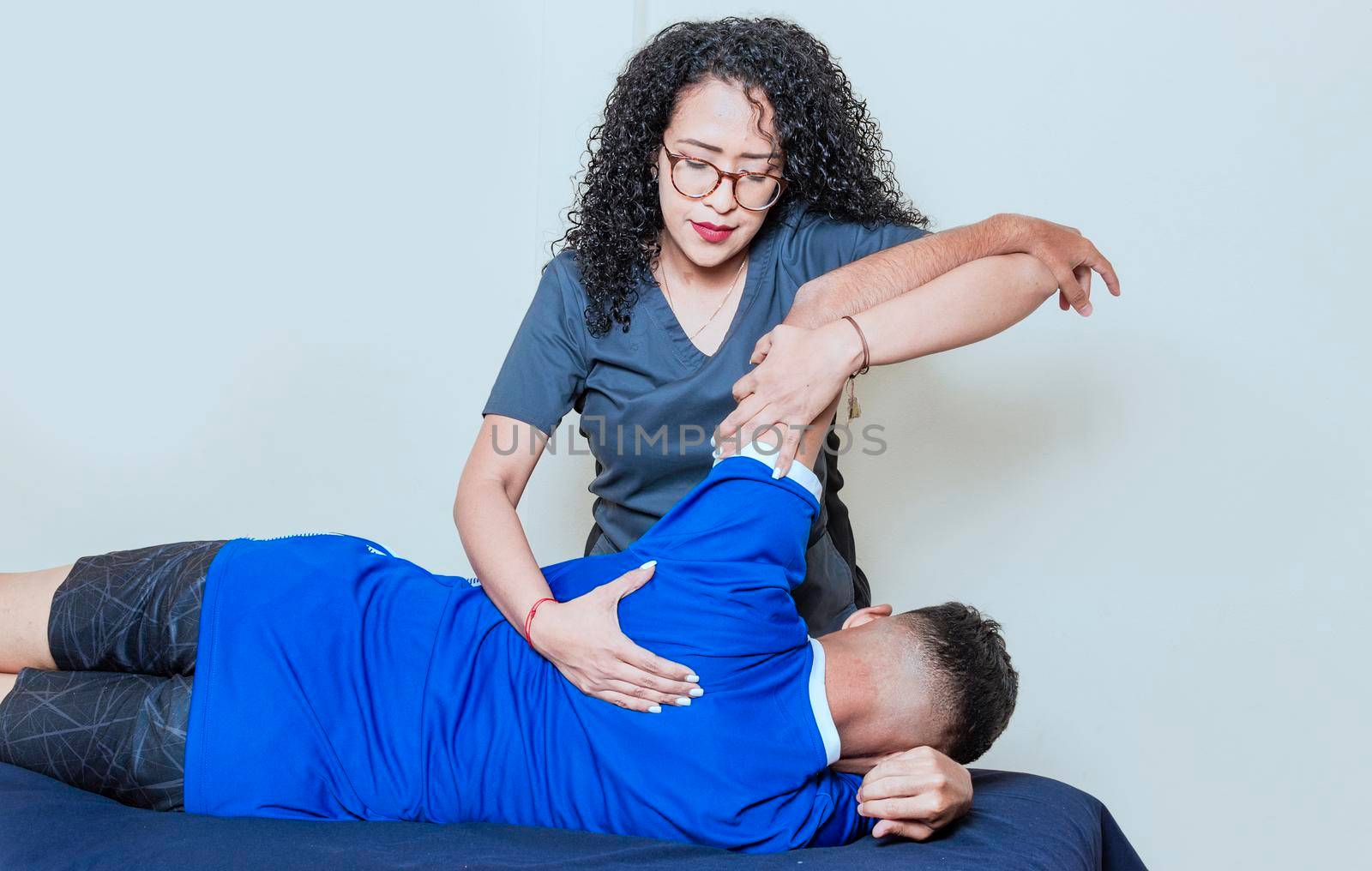 Female doctor with patient undergoing back treatment, Back rehabilitation physiotherapy,