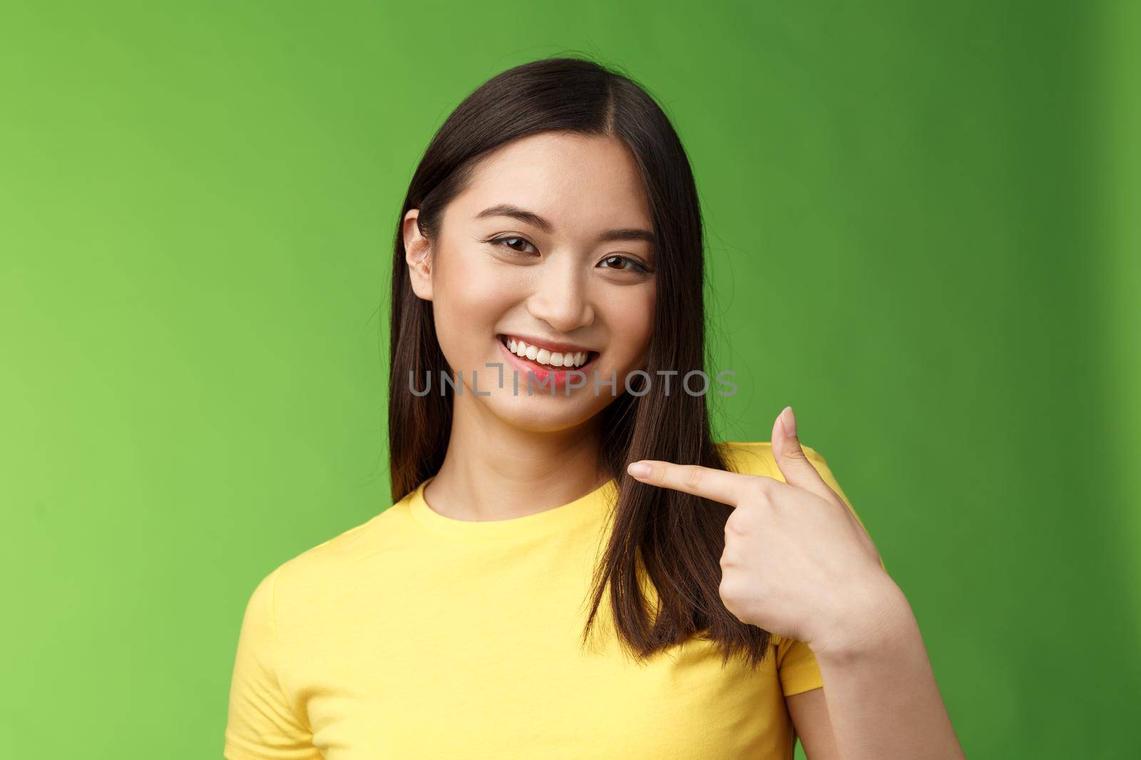Close-up joyful proud asian assertive girl introduce herself, pointing own face smiling joyfully, boastful telling own achievement, bragging accomplishment, assure can deal with work by Benzoix