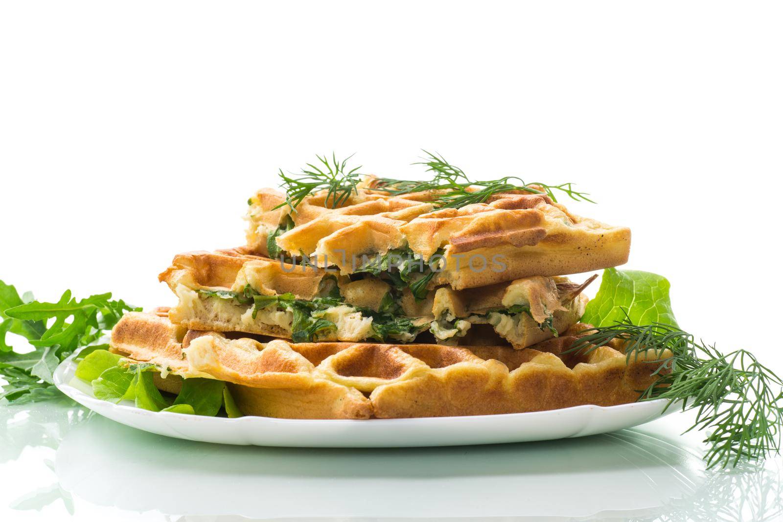 Homemade fried vegetable waffles with greens inside isolated on white background