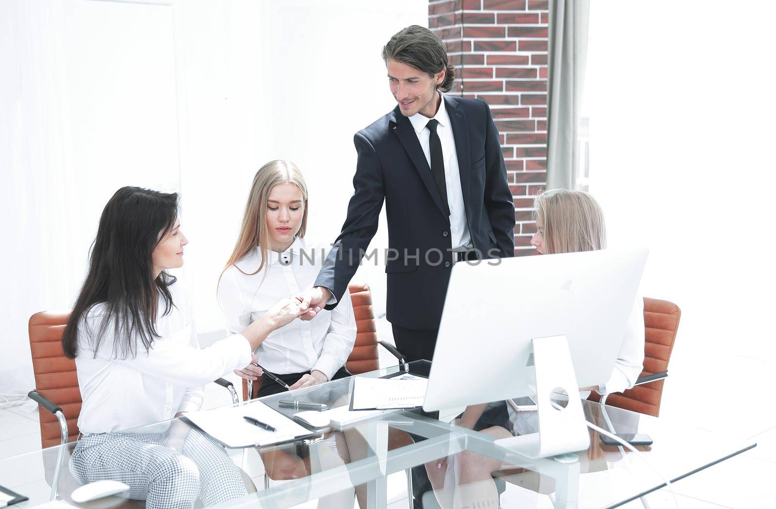 business woman welcomes the client with a handshake by SmartPhotoLab