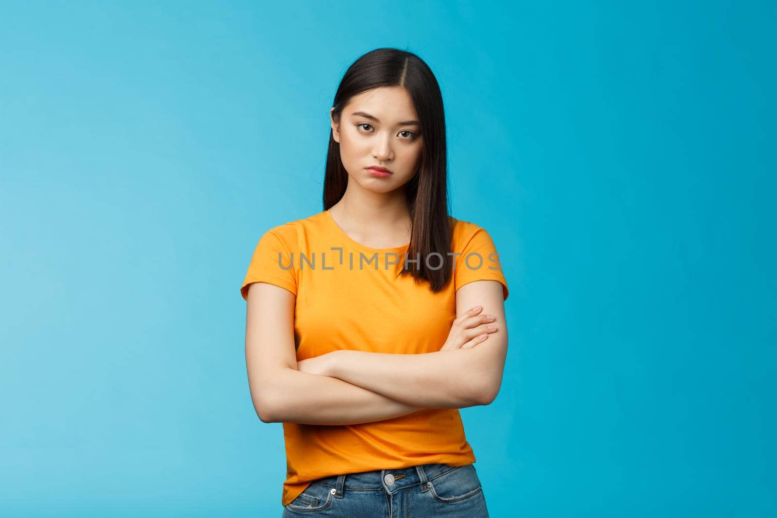 Serious-looking indifferent and upset intense asian woman brunette, cross arms chest look strict ignorant, pissed listening nonsense, annoyed stupid conversation, stand blue background by Benzoix