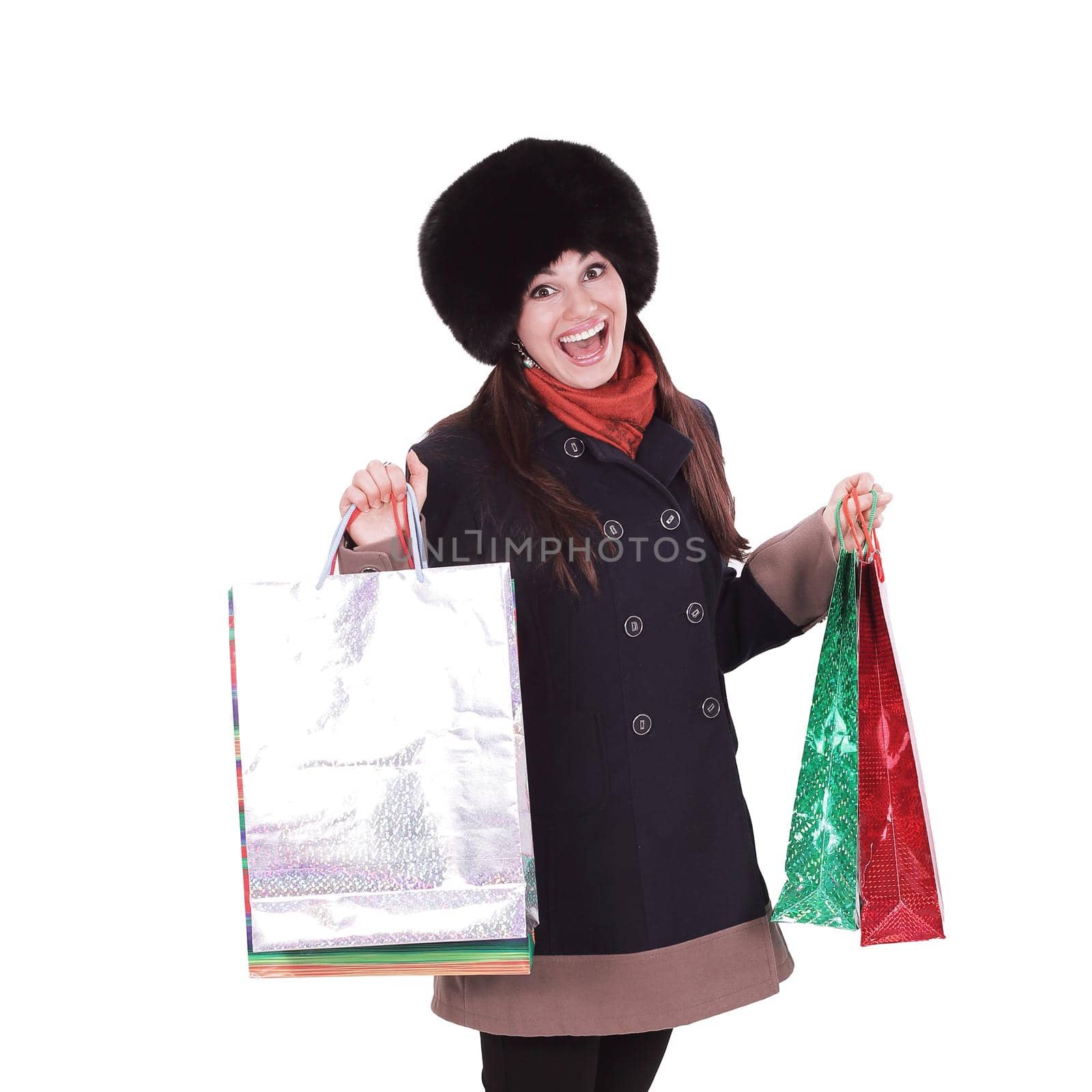 young woman in winter clothes with shopping bags .isolated on white background