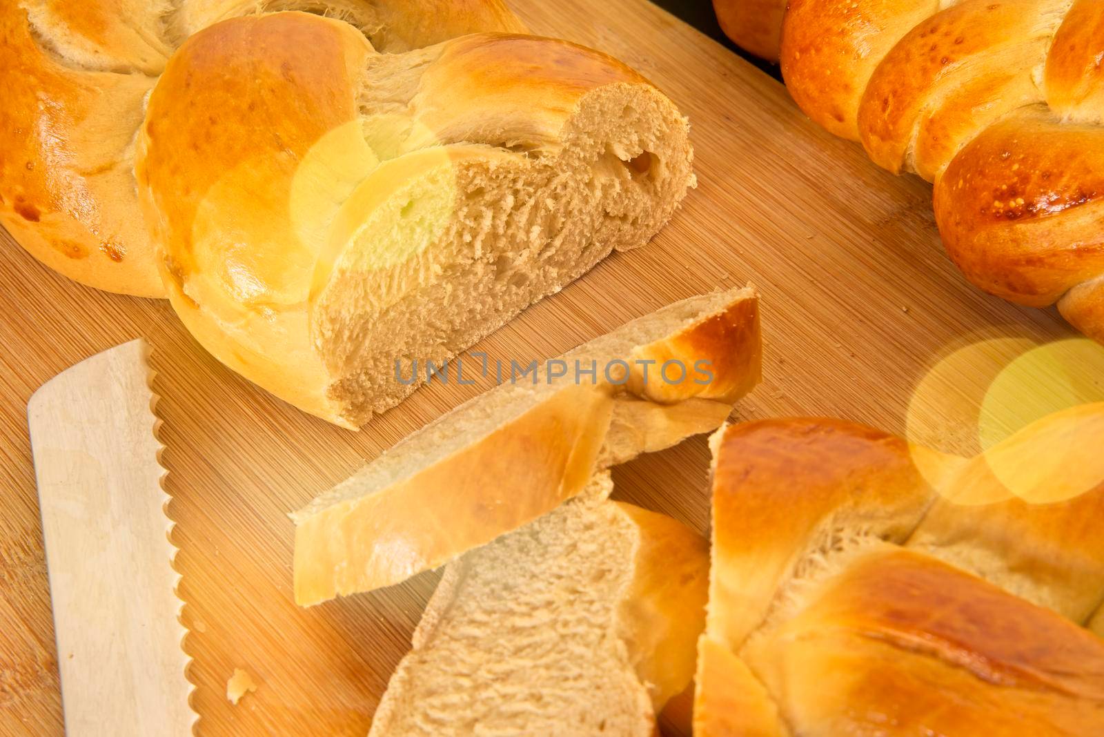 Bread in the shape of a braid. Sweet Challah. Slice of banana bread for breakfast, side view. Cherry tomatoes . High quality photo