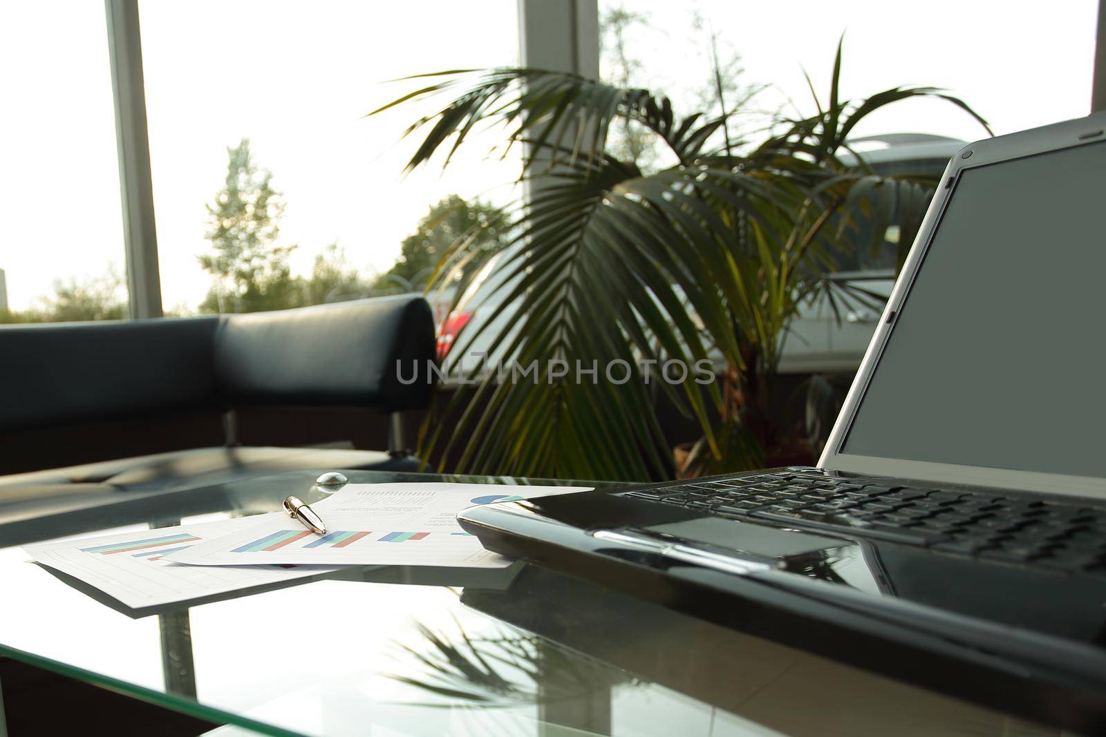 close up. open laptop on the table in the lobby of a modern Bank by SmartPhotoLab