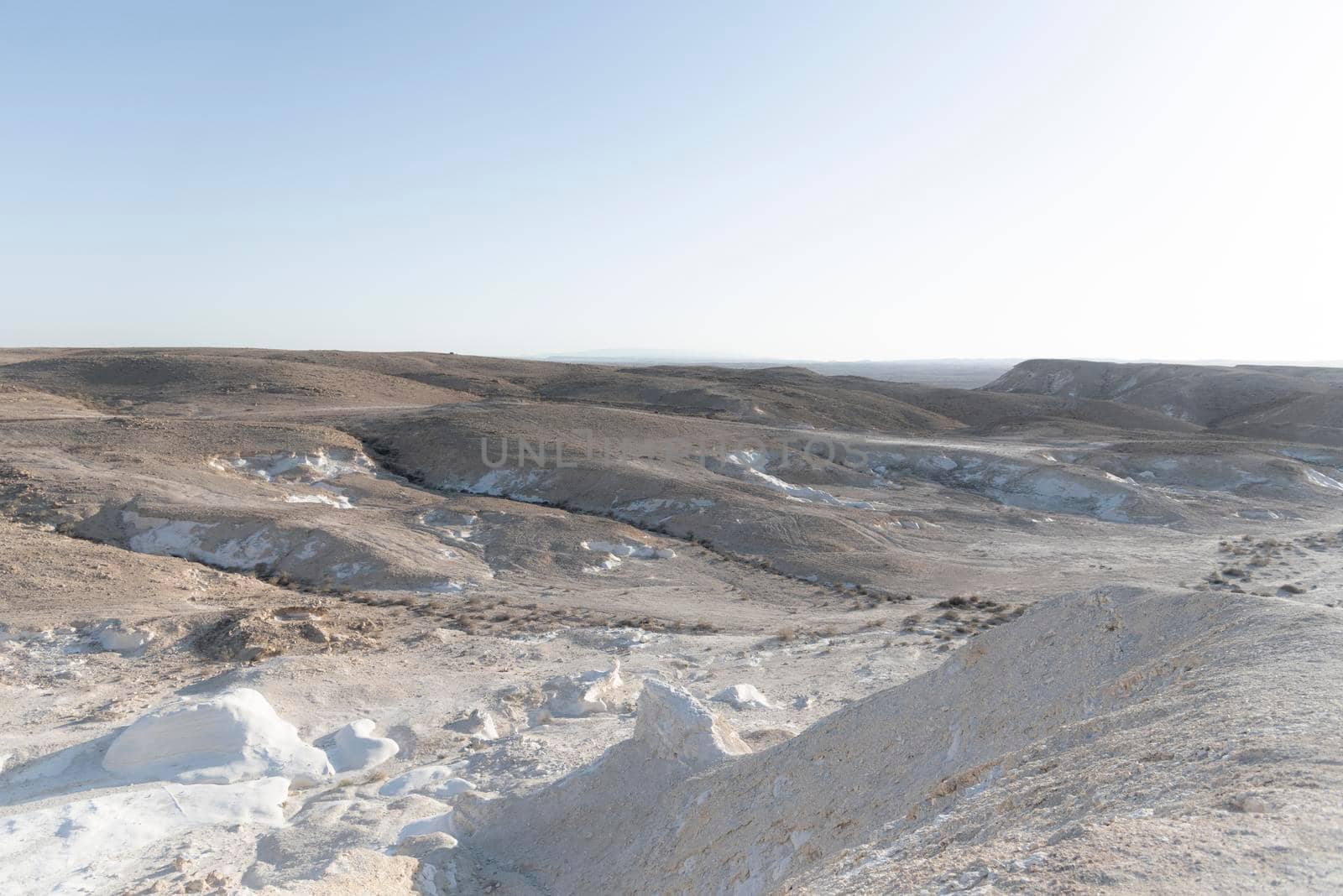 Beautiful lunar landscape. Wight and smooth hills in various shapes in a desert landscape. The whitish, rounded, winding, and smooth chalk rocks. Israel. High quality photo