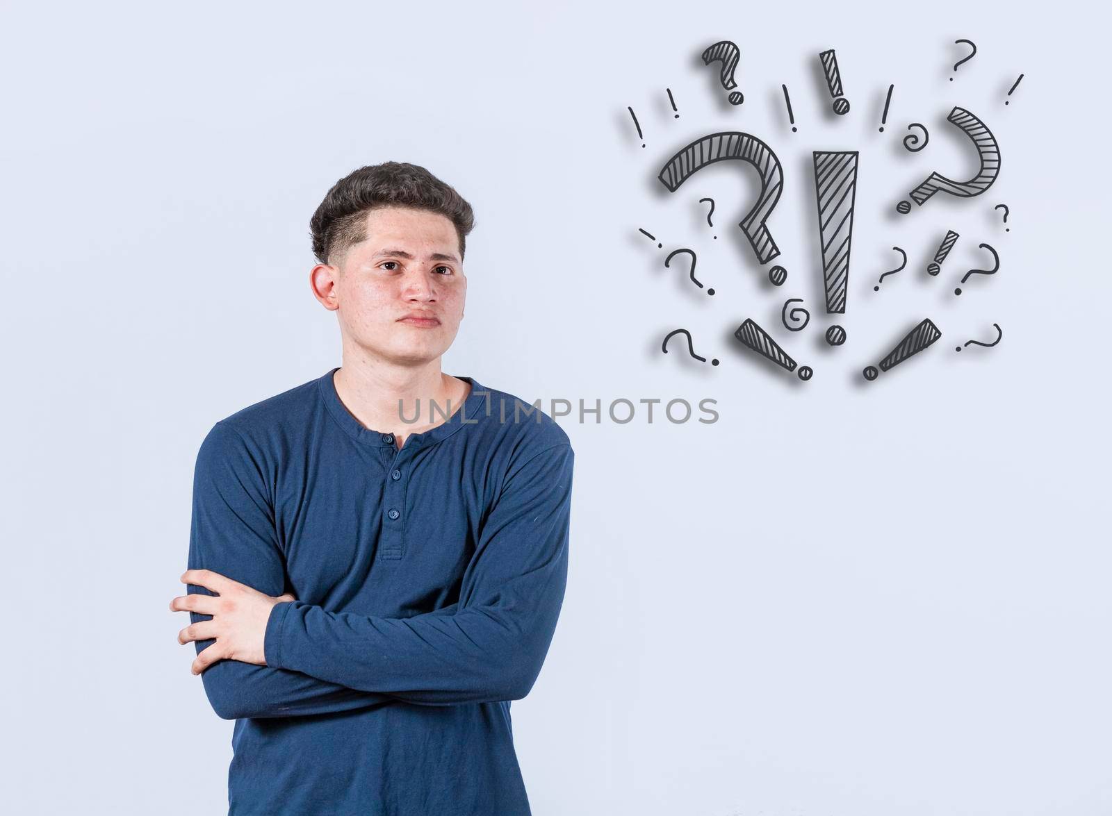 Thoughtful young man looking up with exclamation marks, Thoughtful man with exclamation marks on isolated background, Indecisive man looking up , Concept of man asking with exclamation marks by isaiphoto