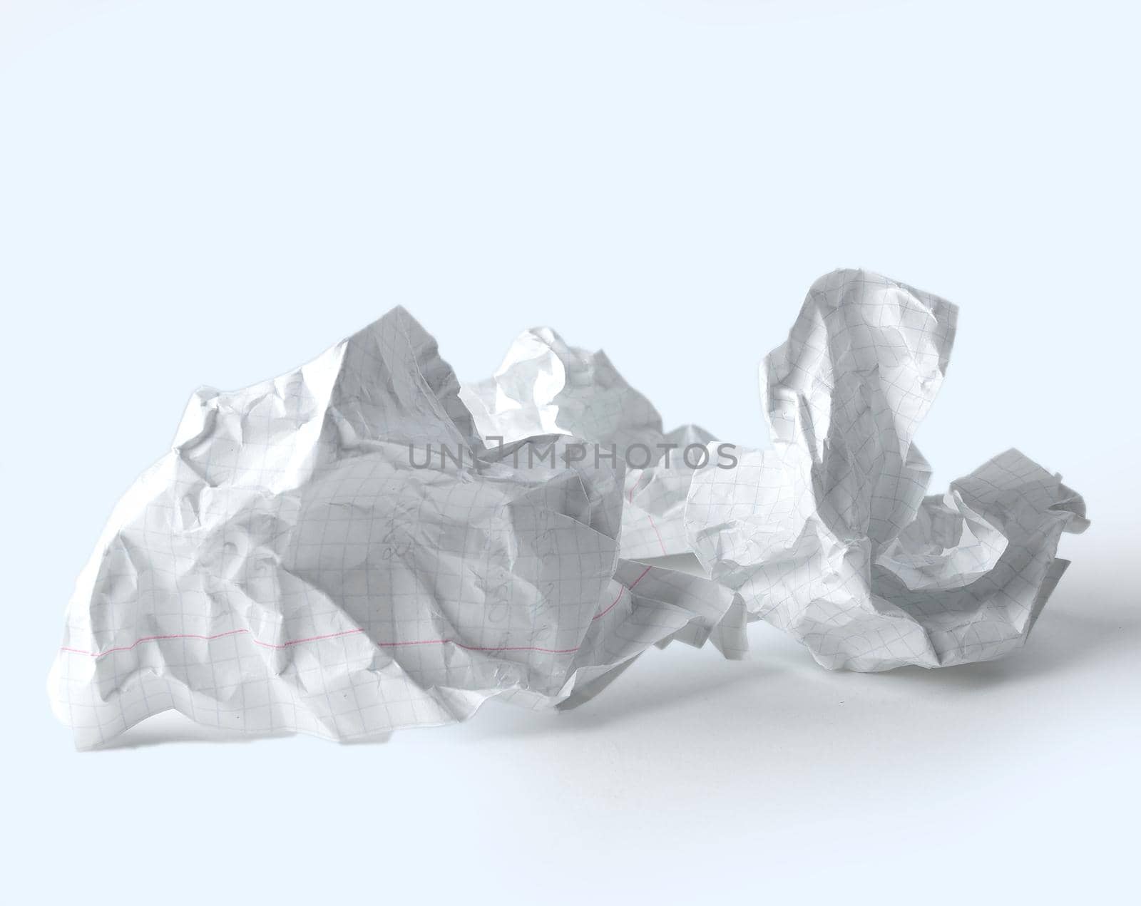 crumpled school notebook sheet on white background.photo with copy space.