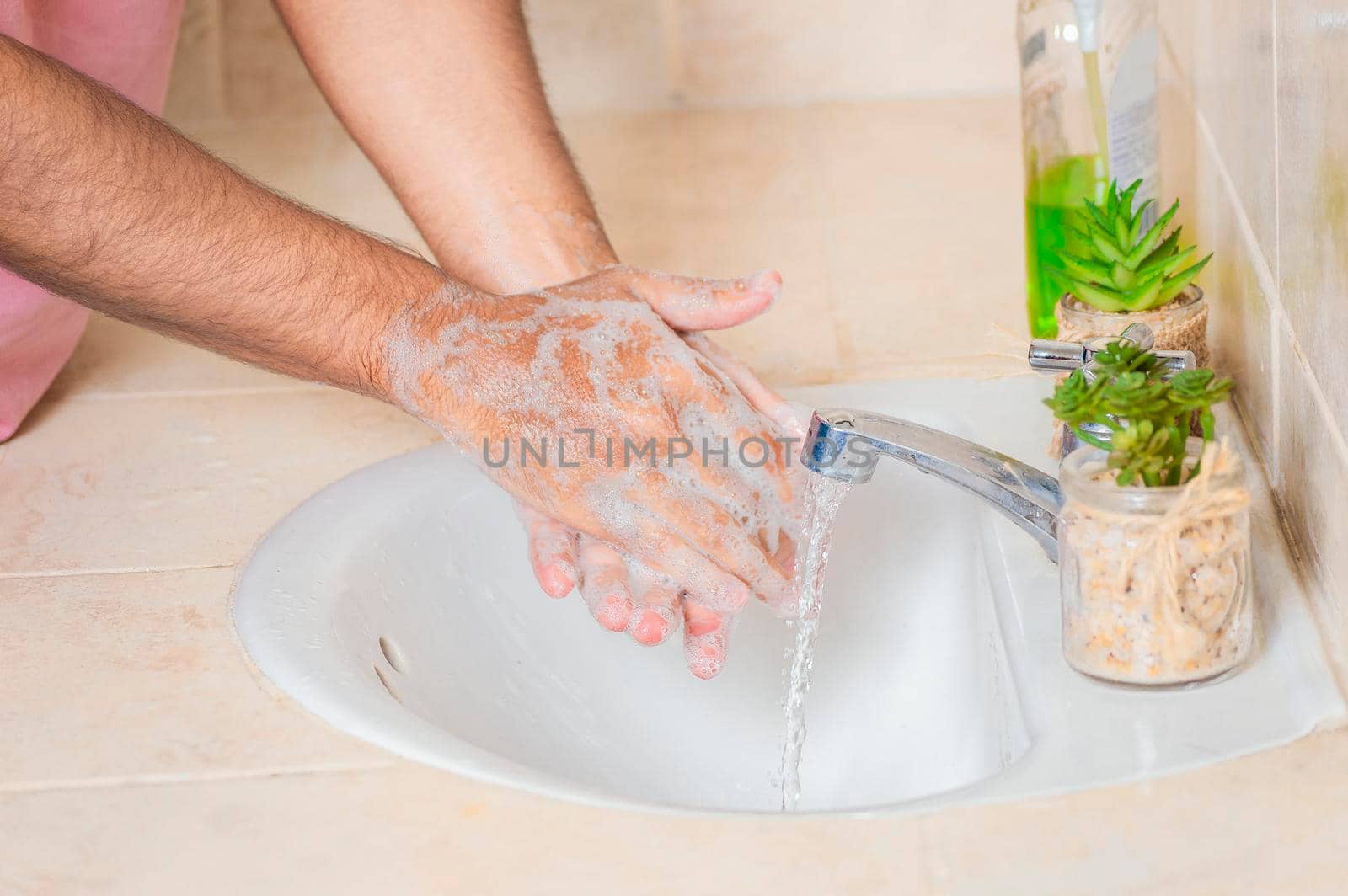 Close up of a man washing their hands with soap, concept of correct hand washing, ways to prevent covid19