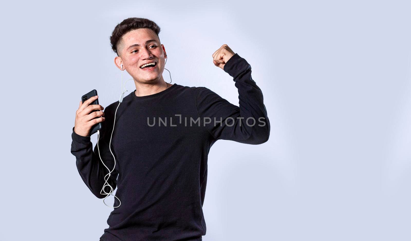 Guy with headphones raising his hand in victory sign, Guy with cellphone raising his hand excited