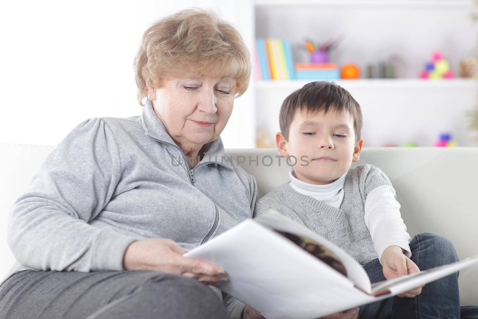 loving grandmother reads a book to her grandson.photo with copy space.