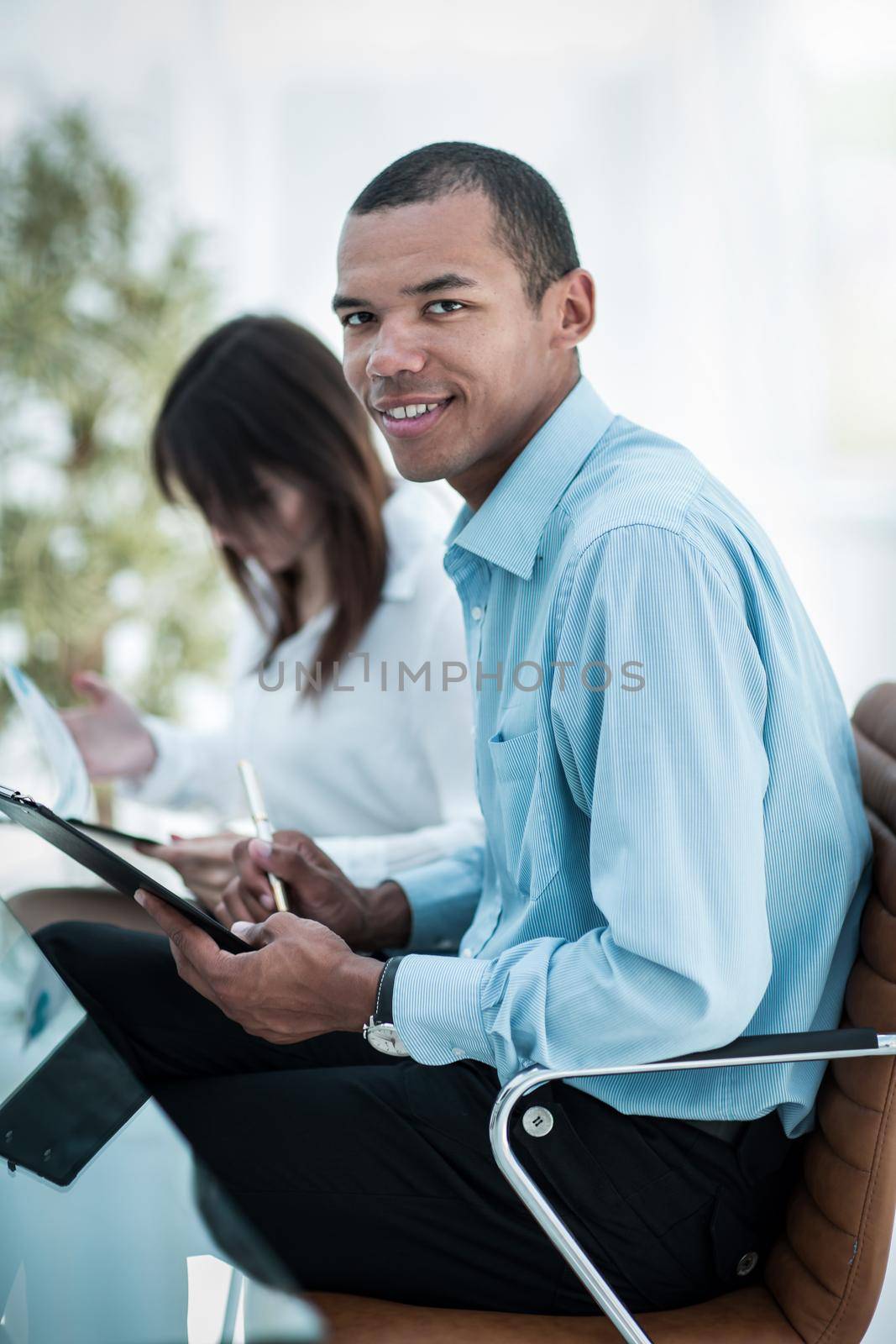 successful young business men with financial document on the background of the office