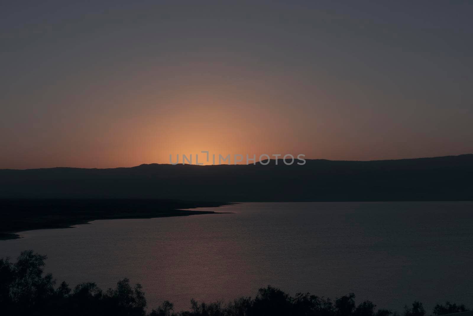 Orange sunrise reflecting off of the Dead Sea. High quality photo