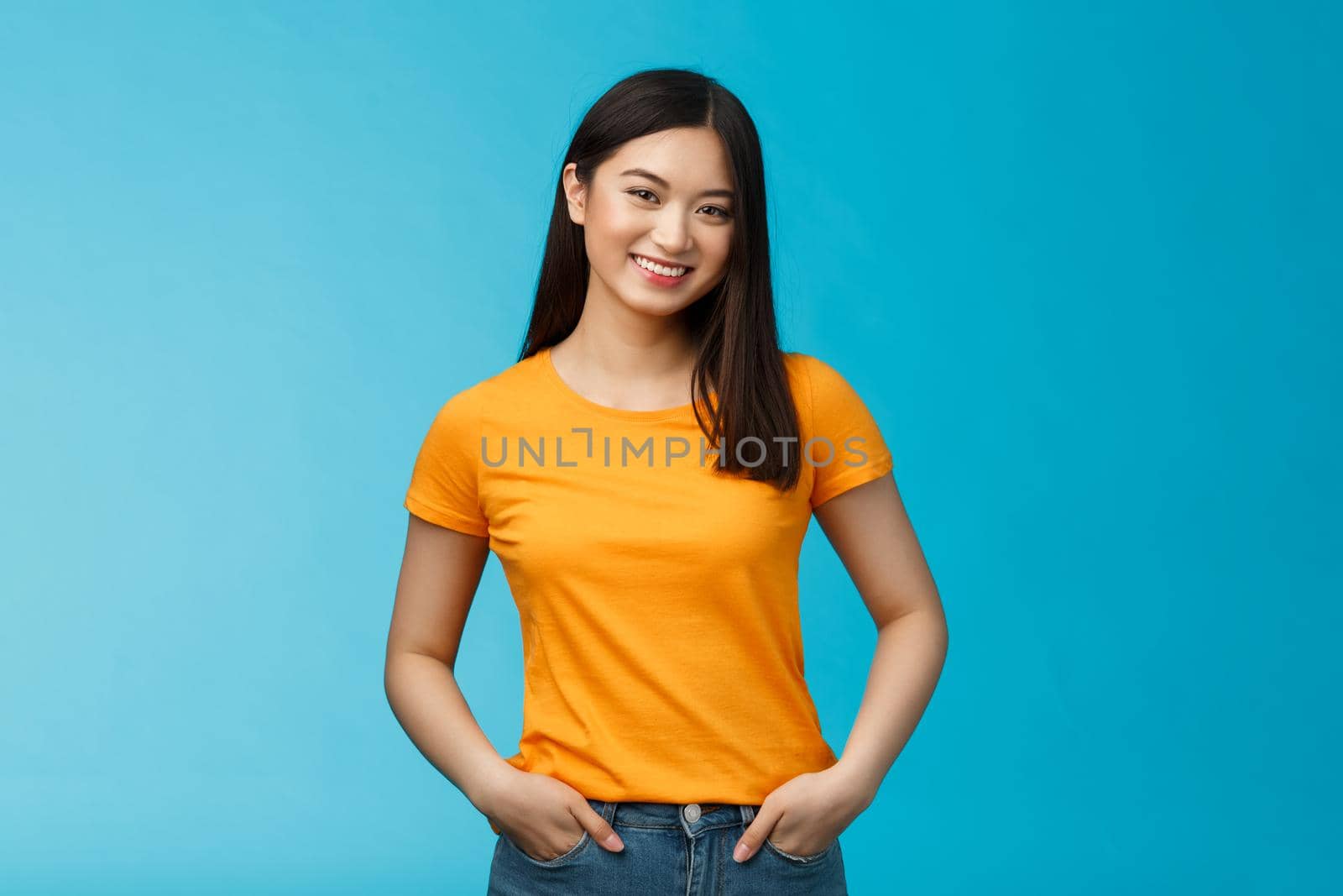 Carefree friendly asian girl with short dark hair tilt head lovely, smiling camera, hold hands jeans pockets, chatting casually, having pleasant normal conversation, discuss weekend picnic plans.