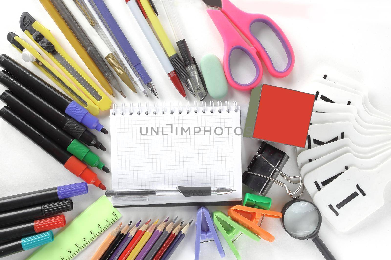 opened Notepad and office supplies on white background.photo with copy space.