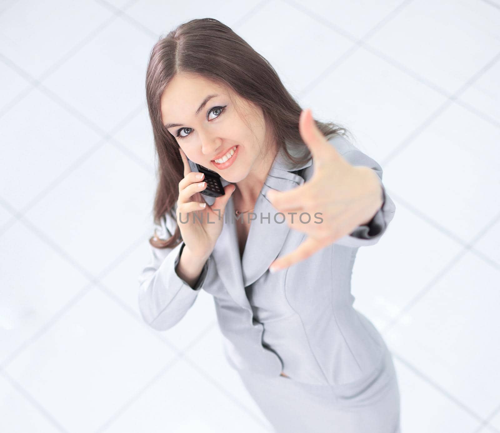 view from the top. successful business woman with a mobile phone .photo with copy space