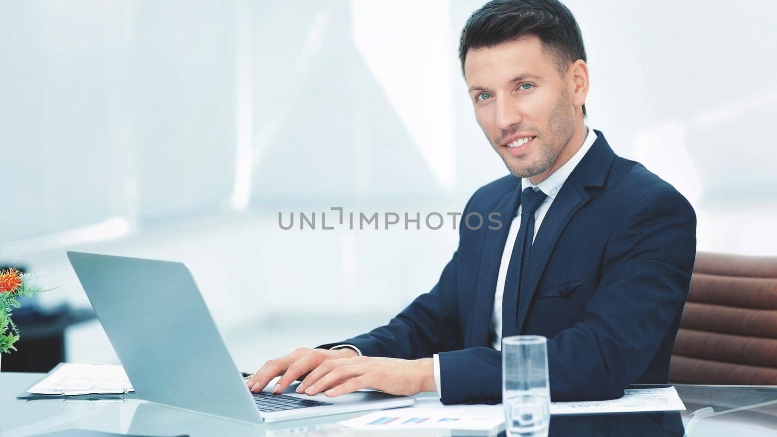 businessman talking on the Internet in the workplace by SmartPhotoLab