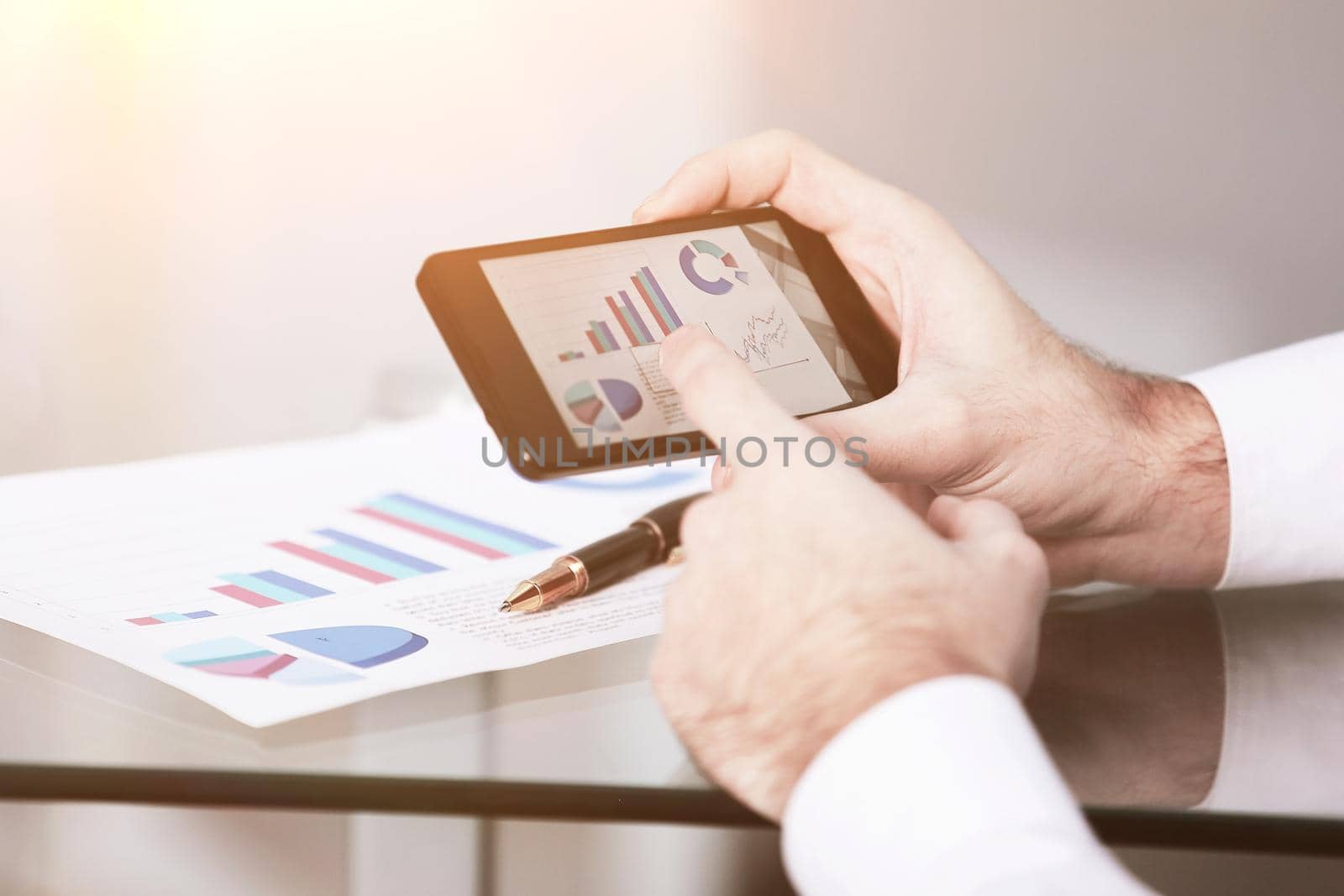 Close up of a man using mobile smart phone by SmartPhotoLab