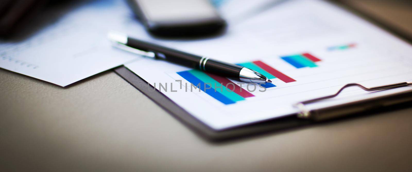 financial charts and graphs on the table by SmartPhotoLab