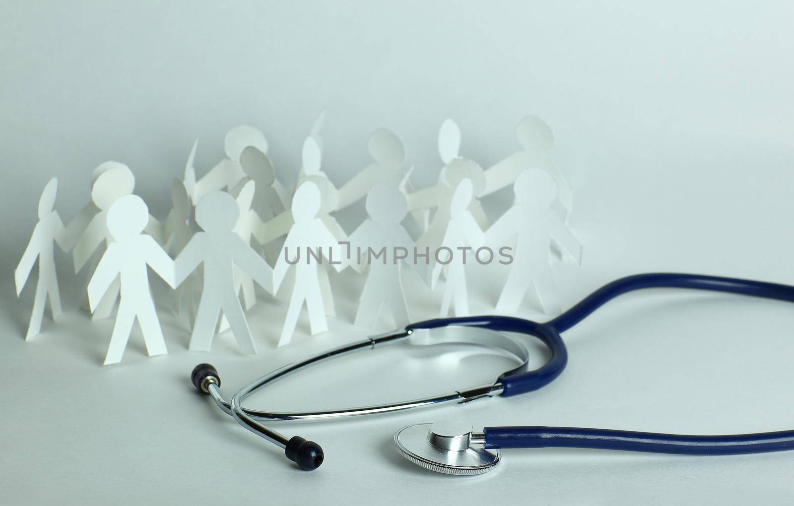 stethoscope and paper men on the table. by SmartPhotoLab
