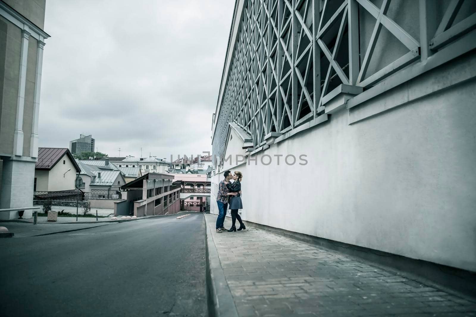 couple in love walking down the street of a modern city. by SmartPhotoLab