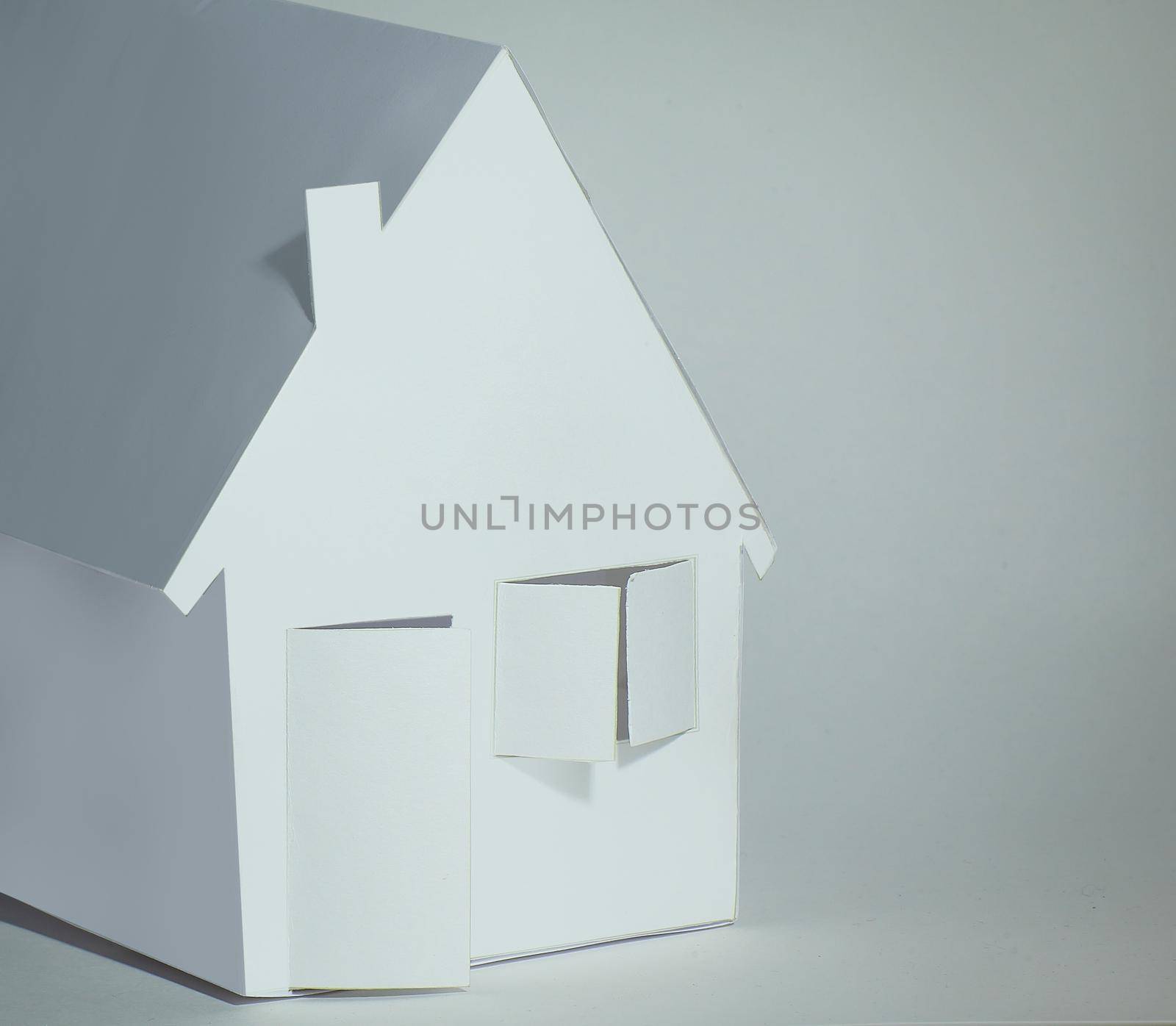 paper house paper background.the concept of a mortgage by SmartPhotoLab