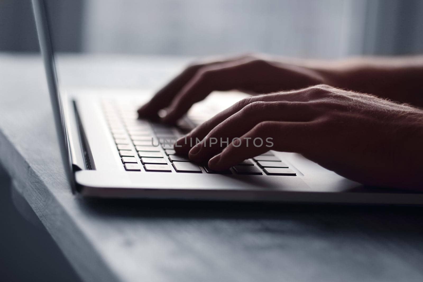 close up.hand of a businessman pressing button on laptop keyboard.