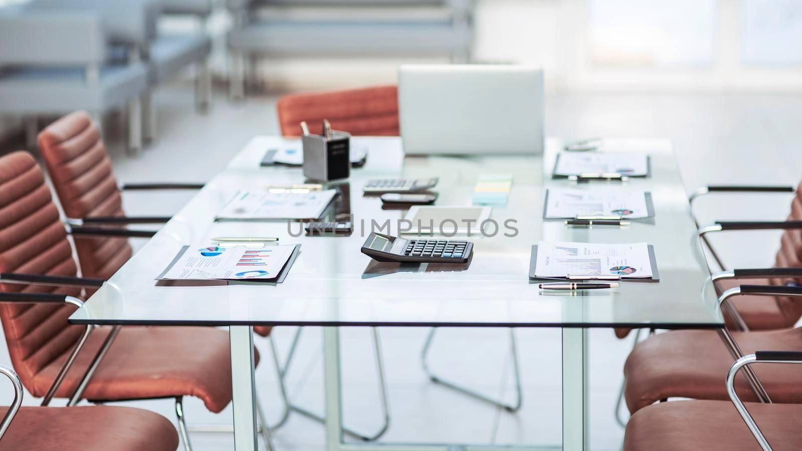 financial charts,calculators,notebook and pens laid out on the desktop before starting business negotiations.the photo has a empty space for your text