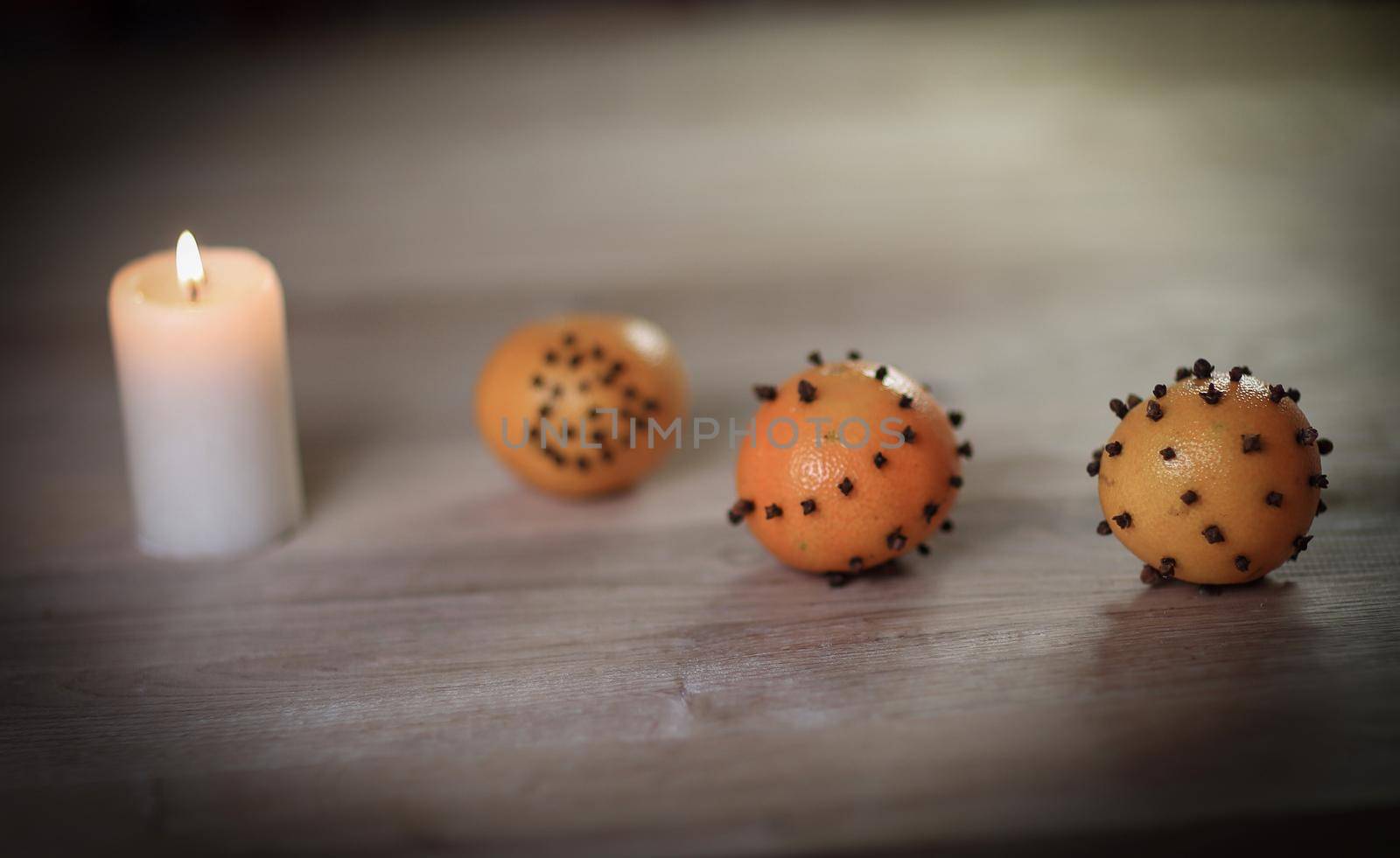 Christmas table. candle and decorated with oranges on wooden background .photo with copy space