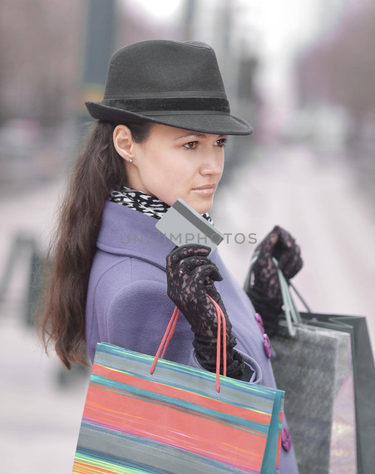 stylish woman with shopping bags showing credit card by SmartPhotoLab